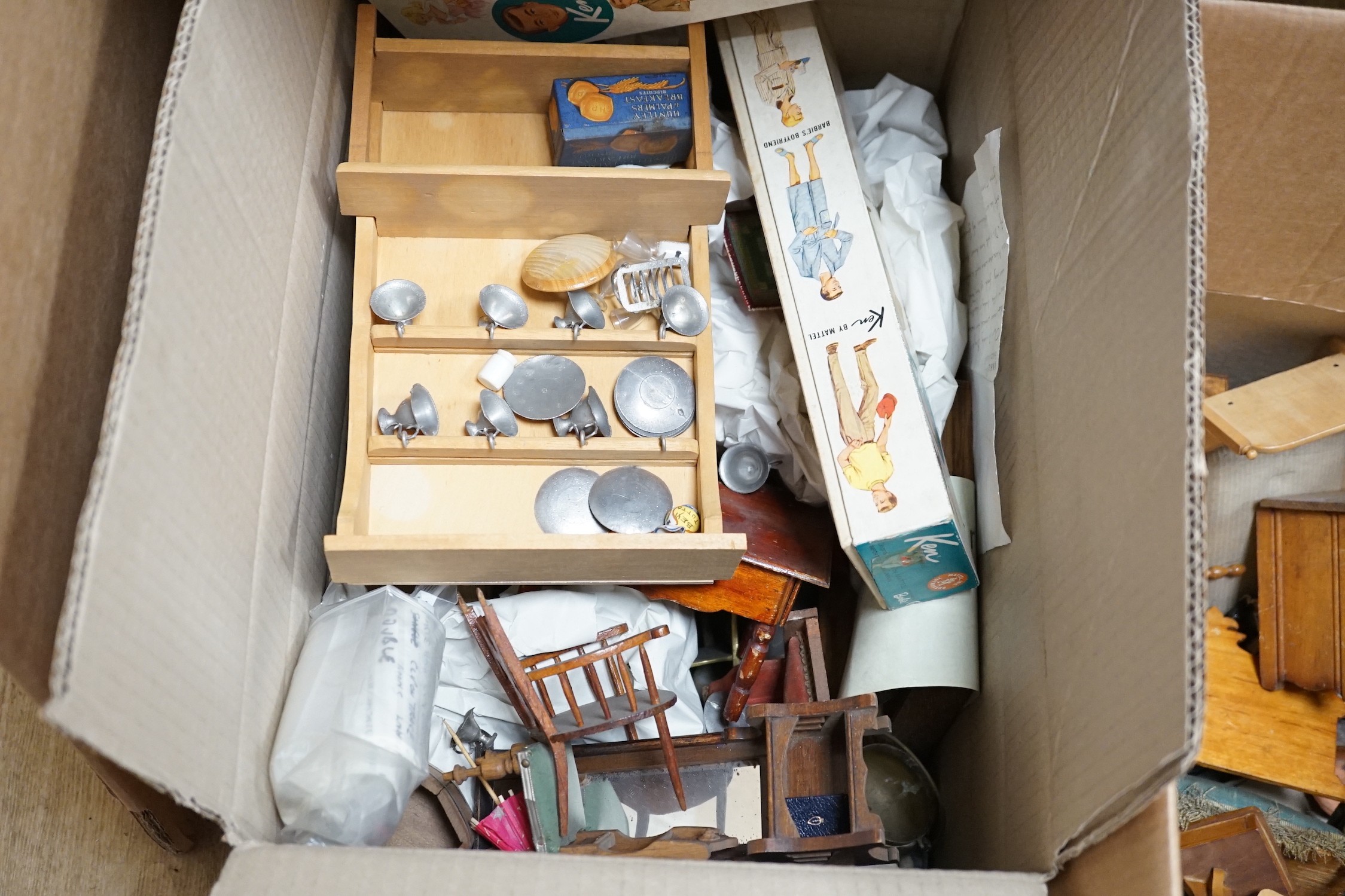 A boxed Ken doll, with another box of Ken clothing